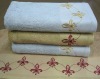 Solid jacquard bath towel with embroidery border