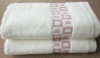 Solid towel with jacquard border