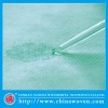 absorbent treament nonwoven for surgical drapes